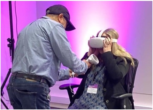 Sarah Howell testing the virtual reality (VR) headset with a staff member of the Hugging Face - The AI community building the future.